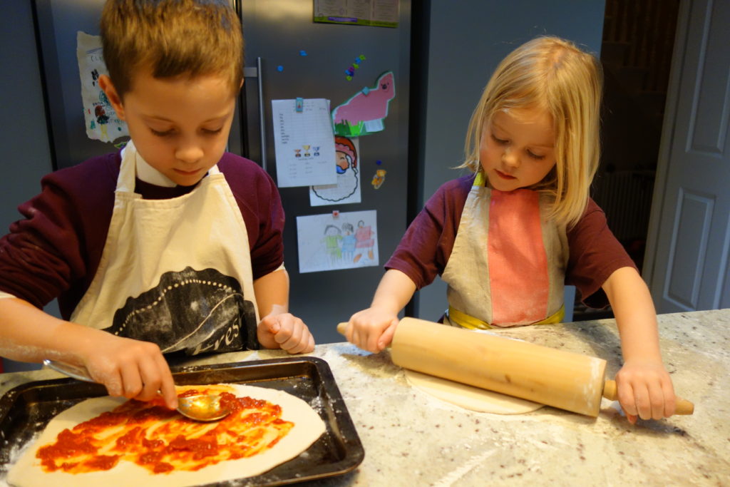 kids making their own pizza