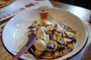 Short stack pancakes with banana and ice cream