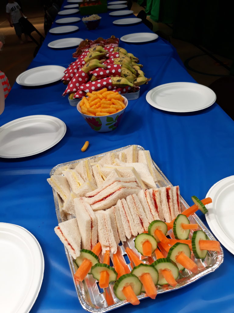 birthday party food including carrot and cucumber pirate swords