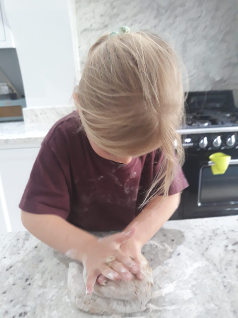 my little chef kneading the dough for pizza making