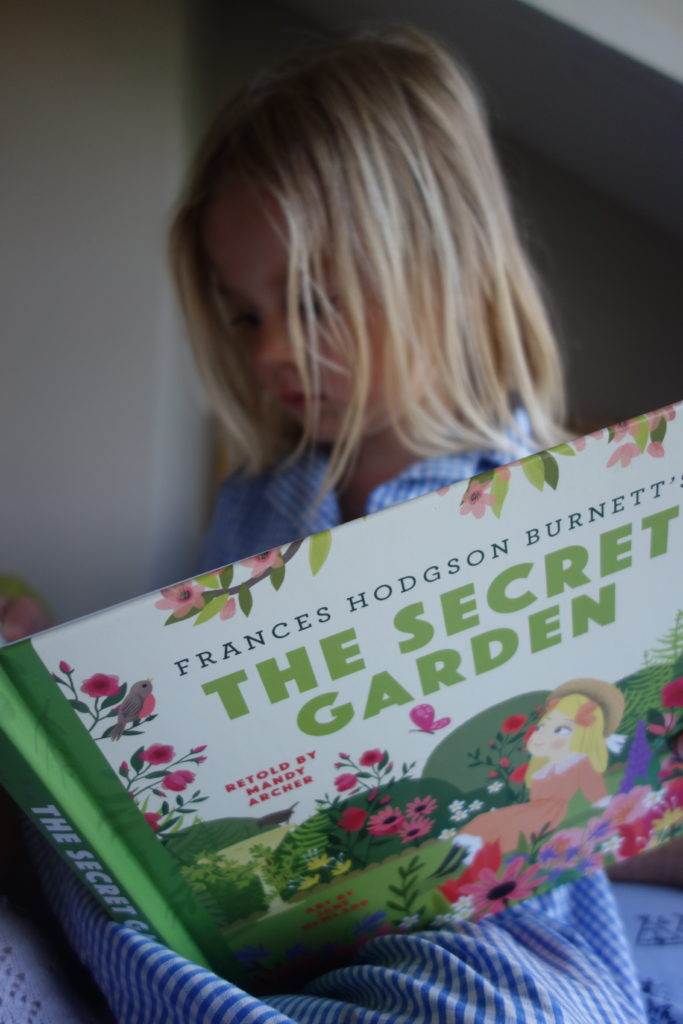 blonde 5 year old reading The Secret Garden by BabyLit