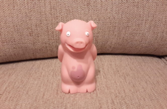 little pink plastic farting pig toy