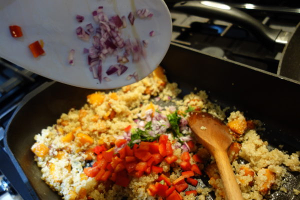 Adding the veg to the quinoa