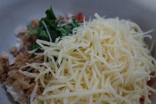 Vegetables chopped in bowl with grated cheese and breadcrumbs