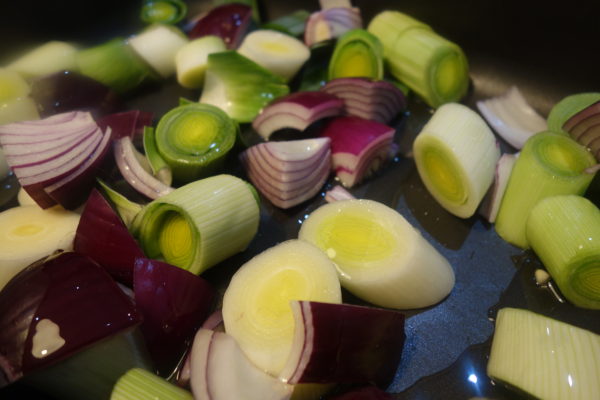 leeks and onions in roasting tray for one tray roast pesto chicken recipe