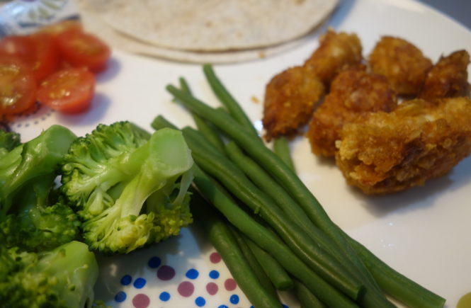 homemade chicken nuggets on a plate with veggies