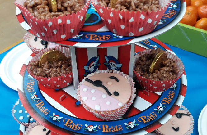pirate cupcakes and buried treasure rice krispie cakes on a stand