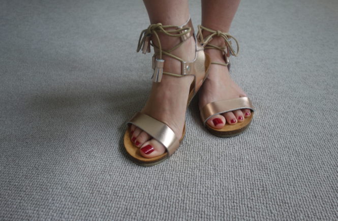 close up of my feet in daisy roots rose gold wimbledon sandal